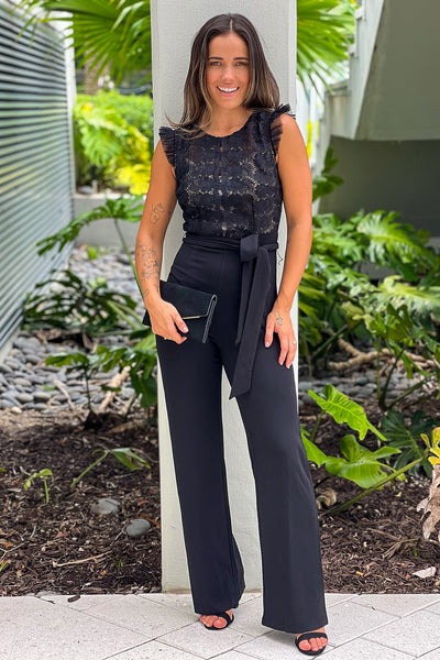 black jumpsuit with lace top and tie belt