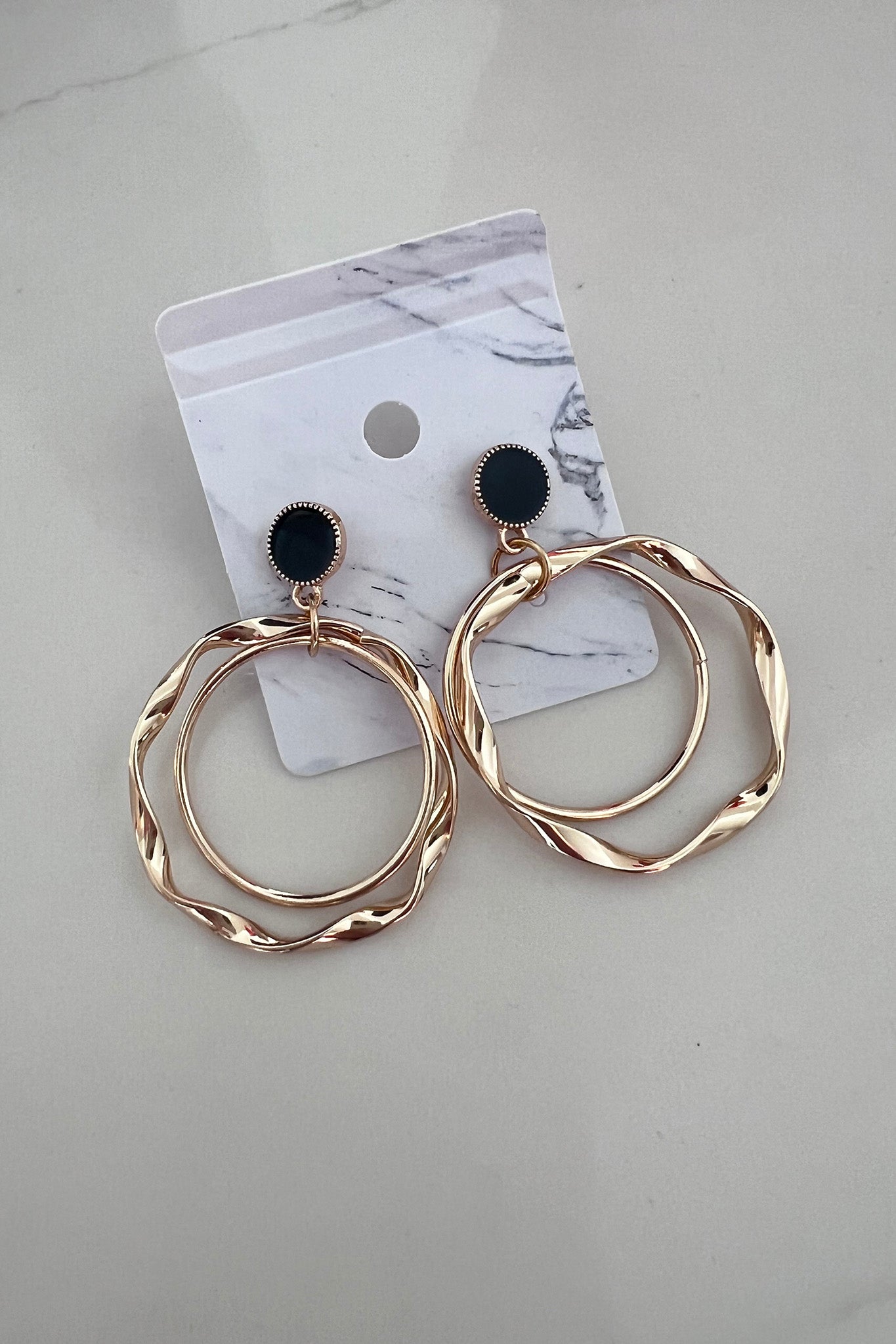 gold hoop earrings with black charm