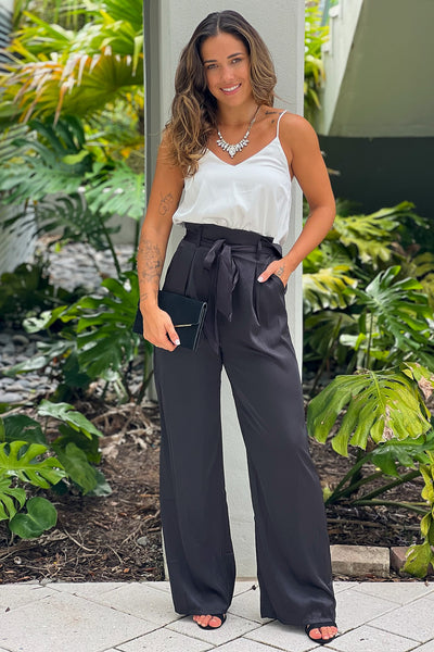 white and black draped neckline jumpsuit with pockets