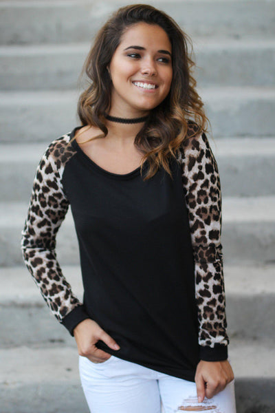 black sweater with leopard sleeves