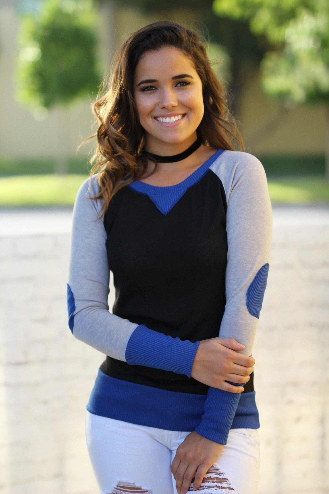 blue and black top with elbow patches