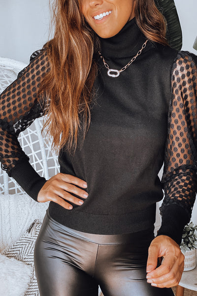 Lifestyle black turtleneck top with sleeve detail