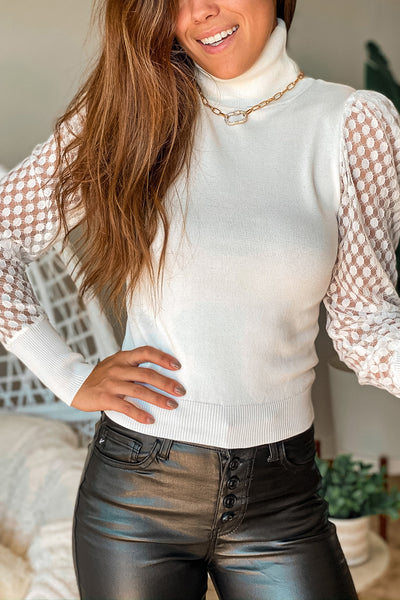 Lifestyle ivory turtleneck top with mesh sleeve detail