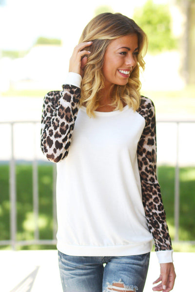 white sweater with leopard sleeves