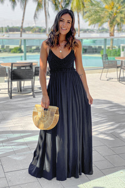 black maxi dress with open back and frayed hem