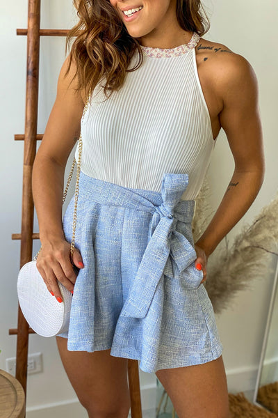 blue and white sleeveless romper with embellished neck