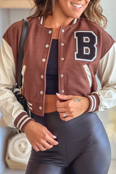 brown patched jacket with cream faux leather sleeves