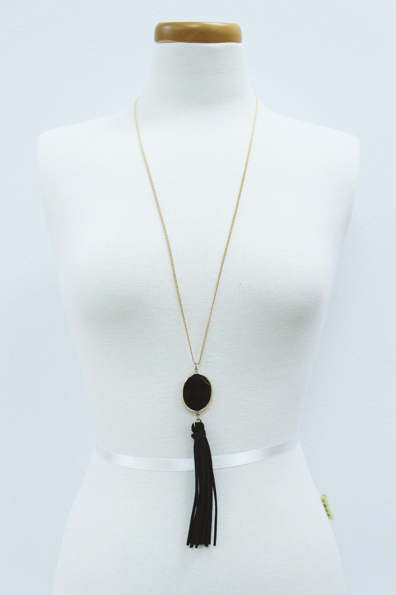 gold necklace with black stone and tassel
