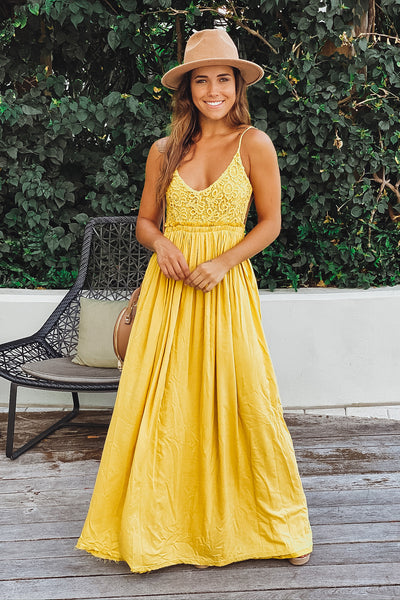 mustard maxi dress with open back and frayed hem