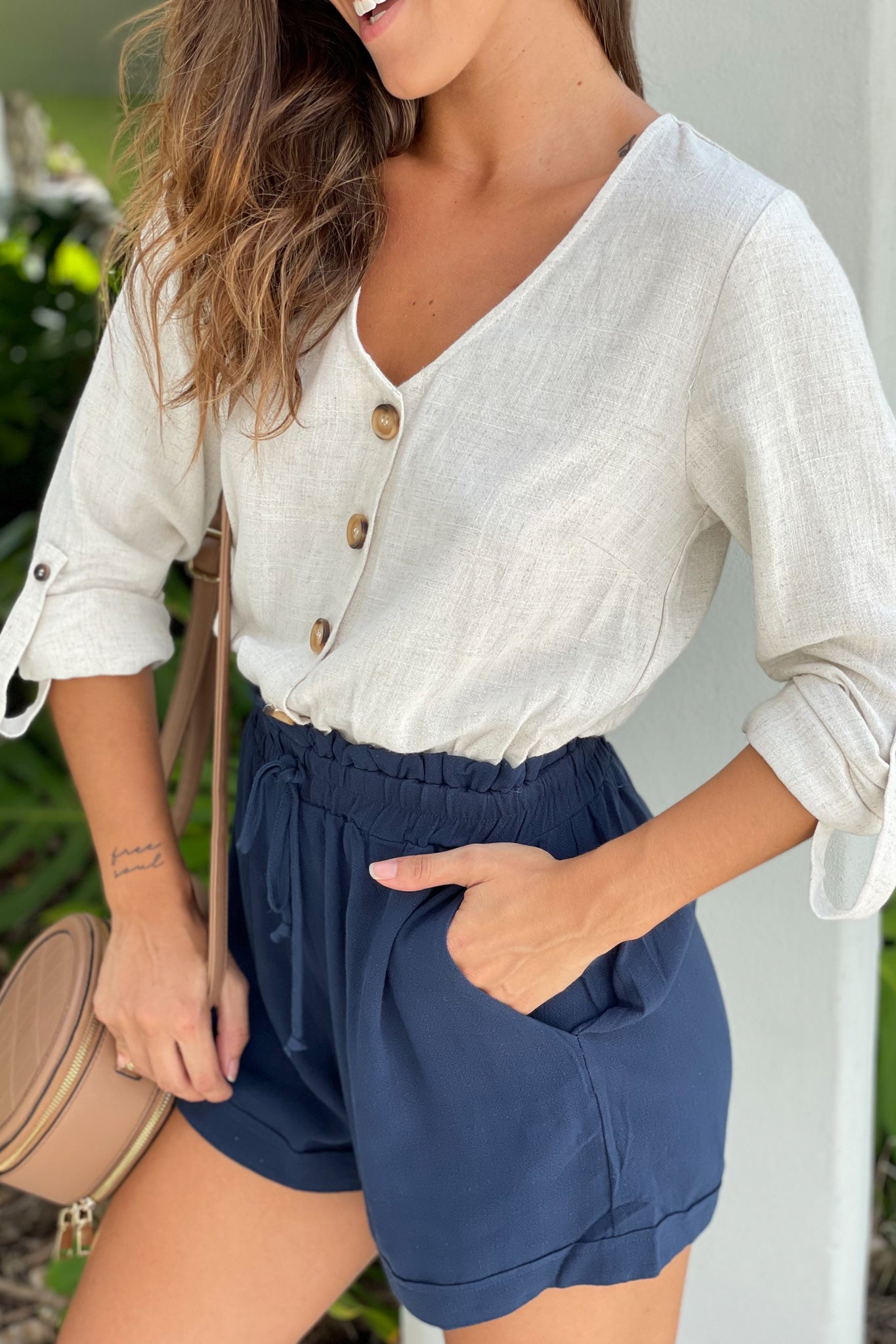 oatmeal and navy button down romper with long sleeves