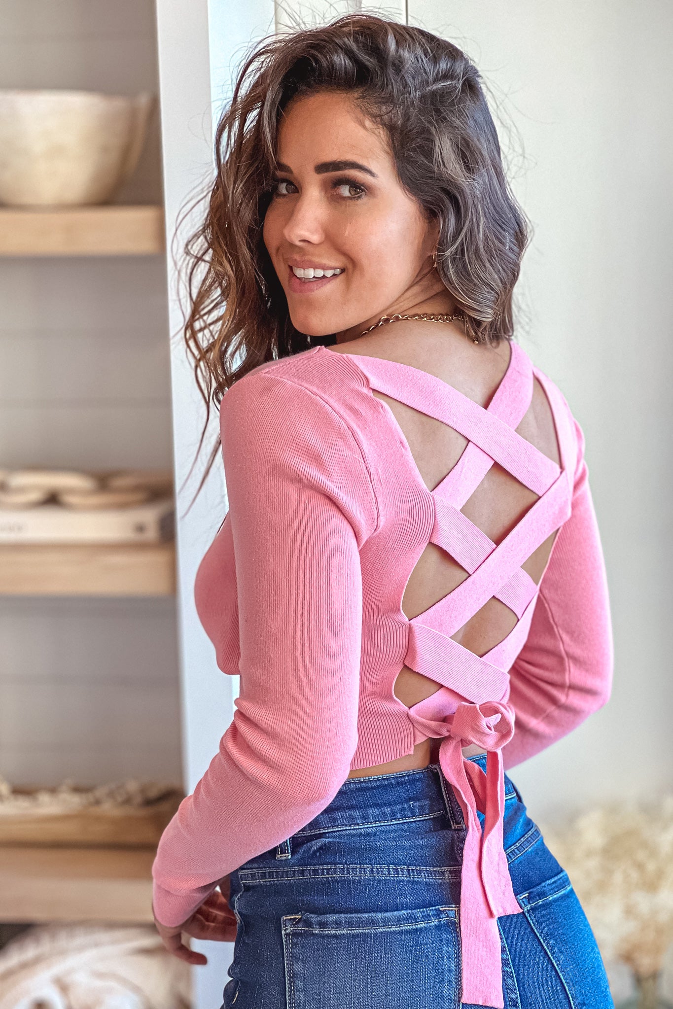 pink knit crop top with long sleeves